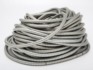 Flexible metal pipe on a white background.