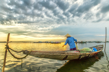 In Hue, Vietnam - June 21, 2015: A man ominous morning nets at Tam Giang lagoon, Hue, Vietnam.