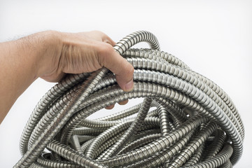 Flexible metal pipe on a white background.