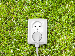 Electric outlet on green grass
