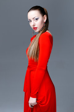 Beautiful female model posing in red dress