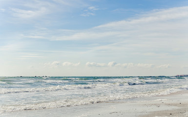 The Black Sea beach with sand and water, blue sky clouds, seaside