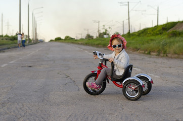 Little girl rides a bicycle