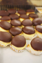 Sweet mini cakes/Sweet mini cakes filled with chocolate and cream. Sweet food. Very shallow depth of field for soft background