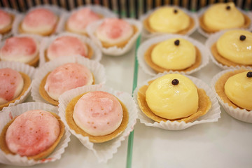Sweet mini cakes/Sweet mini cakes filled fruit cream. Sweet food. Very shallow depth of field for soft background.