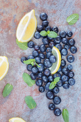 Fresh Blueberries  and lemon slice on  rustic table