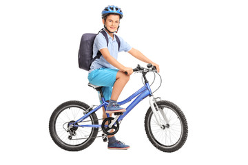 Studio shot of a schoolboy riding a bicycle
