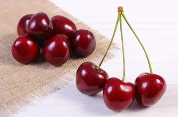 Fresh cherries on white wooden table, healthy food
