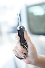 Beautiful girl showing a key