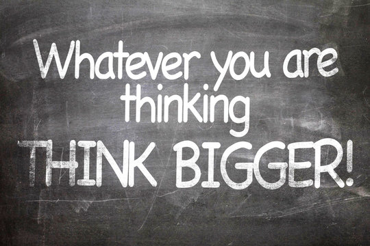 Whatever You Are Thinking Think Bigger written on a chalkboard
