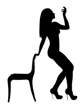 Silhouette of a woman dancing near the chair