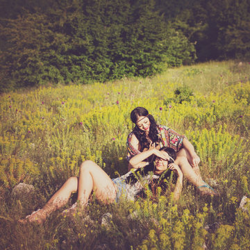Two hippie boho girls outdoors in summer