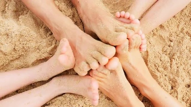 Sandy feet playing in the sand
