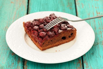 Delicious homemade cherry chocolate pie with fork in white plate