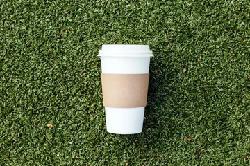  Blank coffee paper cup on football field © stasknop
