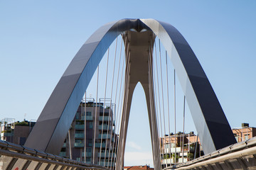 modern footbridge with supporting arches and steel bulkheads