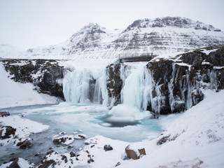 Fototapeta na wymiar Kirkjufellsfos Waterfall in the winter in Iceland