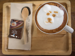 bear latte art coffee cup on a wooden table