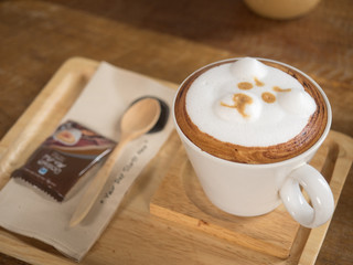 bear latte art coffee cup on a wooden table