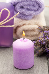 Candle and lavender soap over wooden table