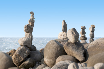 balancing stones on the beach in summer