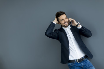 Young man with mobile phone in the office