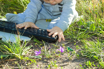 Kid studying keyboard Outdoors.