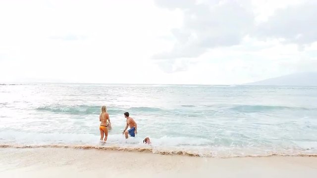 Family playing in the ocean together