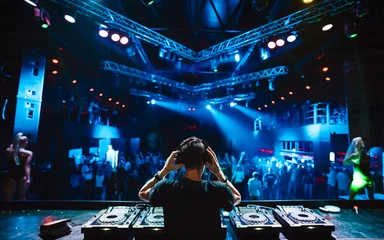 Fotobehang DJ with headphones at night club party   © glazok