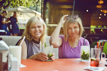 two women  in outdoor cafe