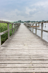 Wooden pier / Wooden pier on water with reeds /