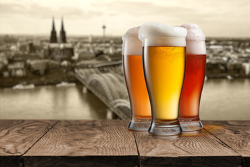 Fototapeta premium Glass of beer with view of Koeln on background