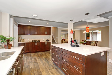 Large kitchen with white counter tops.
