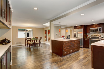 Large kitchen with white counter tops.