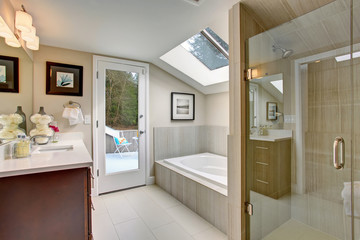 Luxury master bathroom with white tile floor.