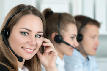 Portrait of call center worker accompanied by her team