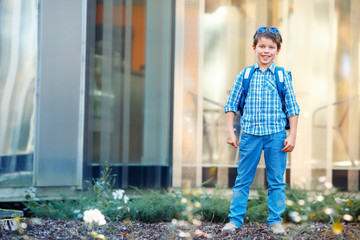 Portrait of cute school boy with backpack