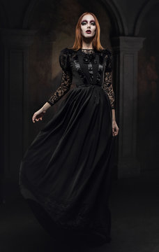 Portrait of gothic girl with black eyes in dark clothes