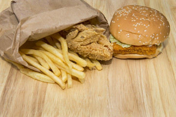 fast food set big hamburger and french fries on wood background