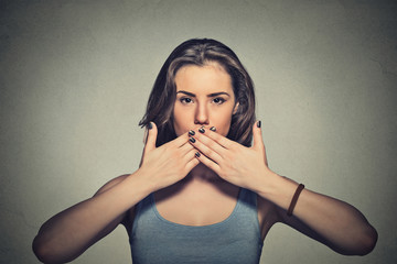 young woman covering with hands her mouth