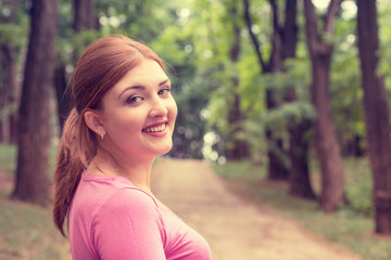 Closeup portrait young smiling woman outdoors in park on summer