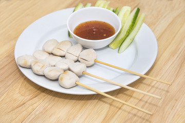 pork meat ball grilled and sauce on wood background