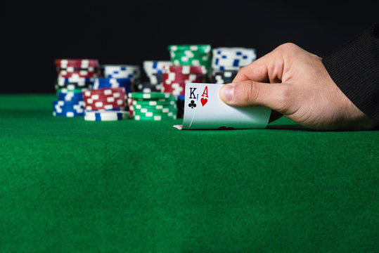 Closeup of poker player with two aces