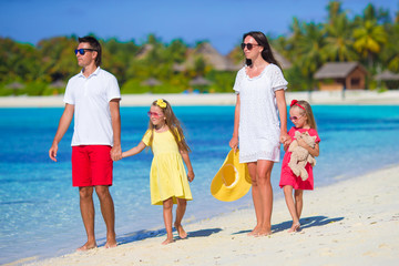 Young happy family with two kids on summer vacation