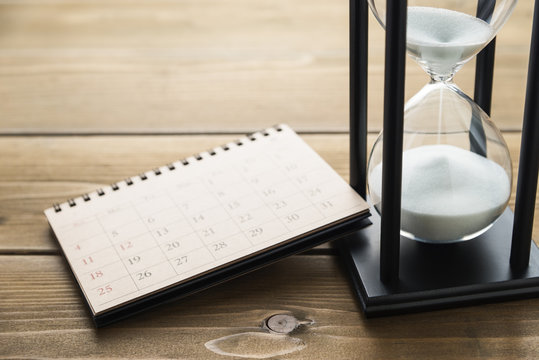Hourglass and calendar.