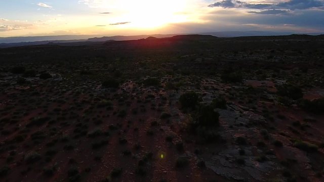 Utah Landscape Aerial flight over the desert towards the sun