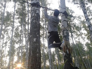 Exercise on the horizontal bar in the woods