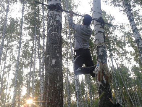 Exercise on the horizontal bar in the woods
