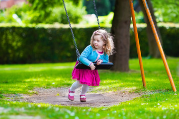 Little girl on a swing
