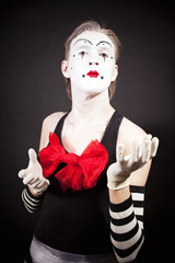 Mime with a red bow in striped gloves